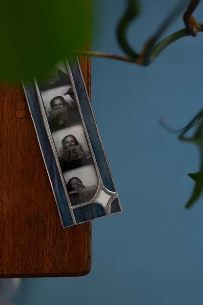 Picture frame on a wooden surface against a blue floor.