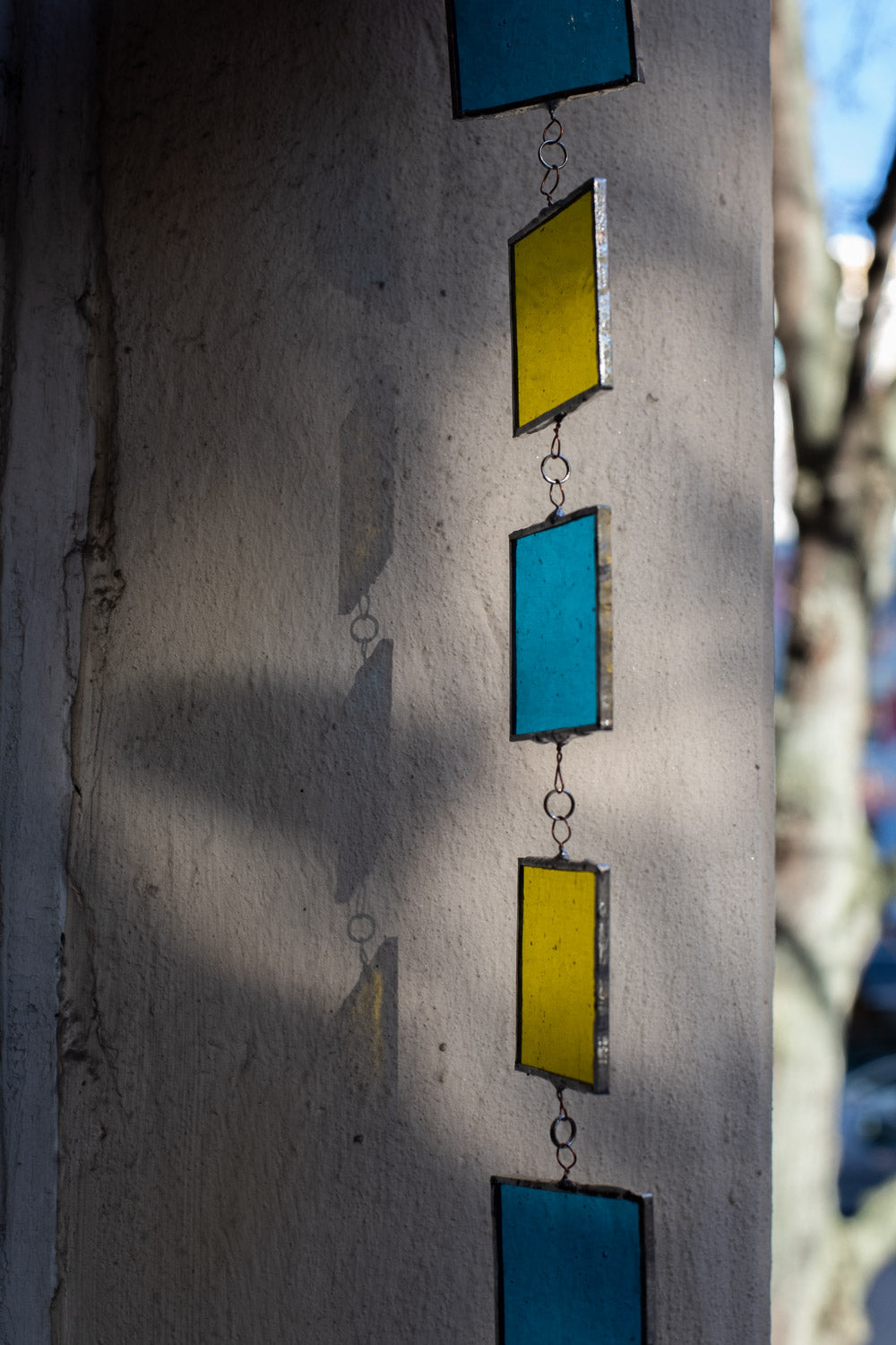 Colorful geometric wall art on a textured wall